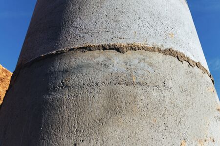 Building plot concrete well for plumbing and sanitary, against a blue sky Close up