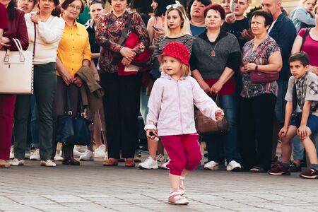 May 25, 2019 Minsk Belarus Street festivities in the evening city Little girl dancing in front of people in the squareのeditorial素材
