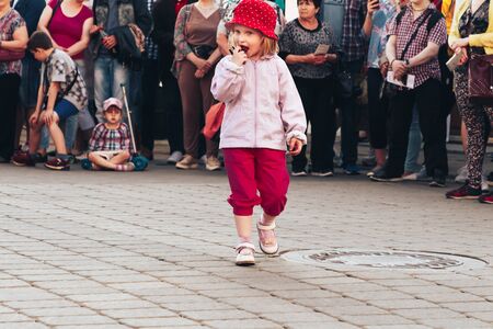 May 25, 2019 Minsk Belarus Street festivities in the evening city Little girl dancing in front of people at a street concertのeditorial素材