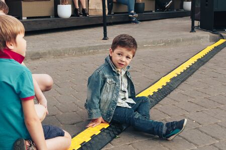 May 25, 2019 Minsk Belarus Street festivities in the evening city A little boy is sitting on the...
