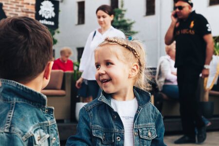 May 25, 2019 Minsk Belarus Street festivities in the evening city Children laugh among the people on the street.のeditorial素材
