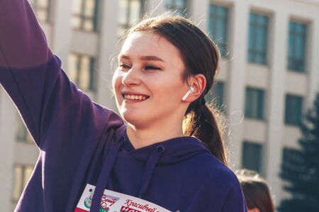 March 8, 2019 Minsk Belarus Women's Day Race on March 8 The girl with the number on the chest does a warm-up before the raceのeditorial素材