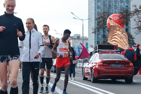 September 15, 2018 Minsk Belarus Half Marathon Minsk 2019 Athletes run along the road among cars and people before the start of the marathonのeditorial素材