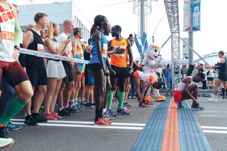 September 15, 2018 Minsk Belarus Half Marathon Minsk 2019 Marathon runners of different skin colors do a warm-up before startingのeditorial素材