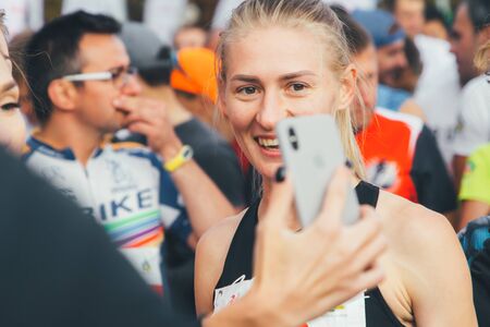 September 15, 2018 Minsk Belarus Half Marathon Minsk 2019 Cheerful female athlete is photographed on the phoneのeditorial素材