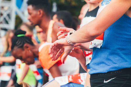 September 15, 2018 Minsk Belarus Half Marathon Minsk 2019 Female marathon runner sets up a stopwatch before startingのeditorial素材