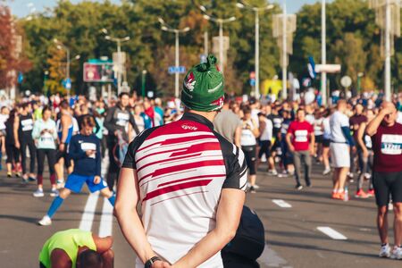 September 15, 2018 Minsk Belarus Half Marathon Minsk 2019 Marathon runner watches the athletes warming up before the start of the half marathonのeditorial素材