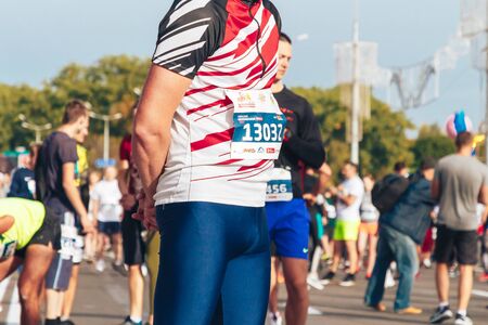 September 15, 2018 Minsk Belarus Half Marathon Minsk 2019 Marathon runner stands among athletes doing warm-up on the road before the start of the half marathonのeditorial素材
