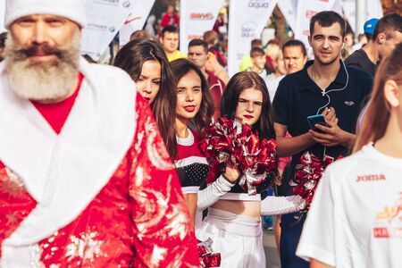 September 15, 2018 Minsk Belarus Half Marathon Minsk 2019 Cheerleader girls are standing next to a man dressed as Santa Clausのeditorial素材