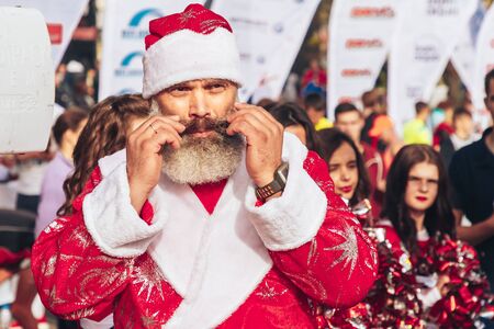 September 15, 2018 Minsk Belarus Half Marathon Minsk 2019 A man in a suit of Santa Claus stands next to the cheerleadersのeditorial素材