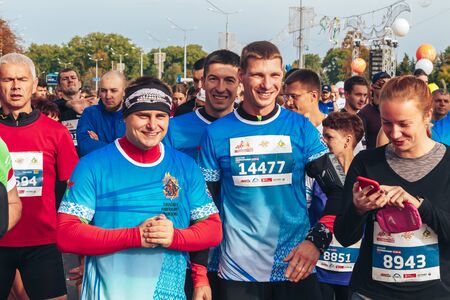 September 15, 2018 Minsk Belarus Half Marathon Minsk 2019 Cheerful marathon runners and a girl with a phone stand before the start of the raceのeditorial素材