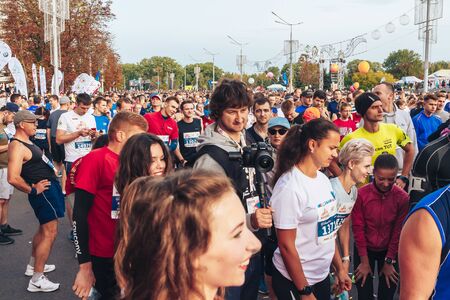 September 15, 2018 Minsk Belarus Half Marathon Minsk 2019 A man with a camera shoots athletes and cheerleader girlsのeditorial素材