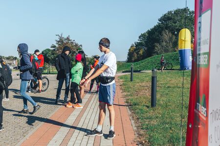 October 6, 2018 Novogrudok Belarus Castle Road The athlete does a warm-up in the park before the...