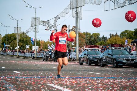 September 15, 2018 Minsk Belarus Half Marathon Minsk 2019 Athlete in a red shirt crosses the finish...