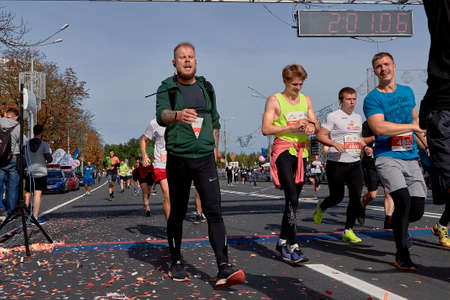 September 15, 2019 Minsk Belarus Half Marathon Minsk 2019 Crowd runners crossing the finish line marathon on paved road in town.のeditorial素材