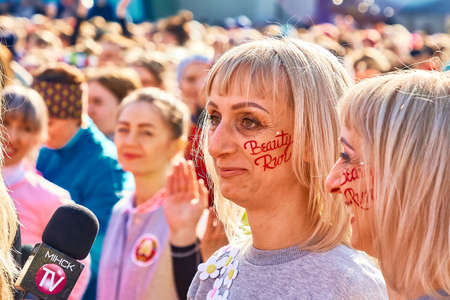 March 8, 2019 Minsk Belarus The inscription, beauty run, on the faces of twin women standing