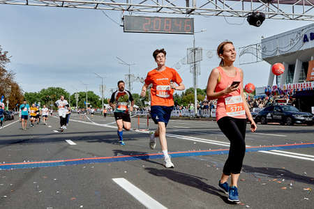 September 15, 2019 Minsk Belarus Half Marathon Minsk 2019 Marathon runners crossing the finish line marathon on paved road.のeditorial素材