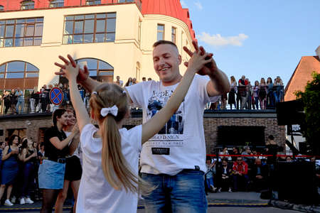 June 1, 2019 Minsk Belarus Father dancing with daughter at a street concertのeditorial素材