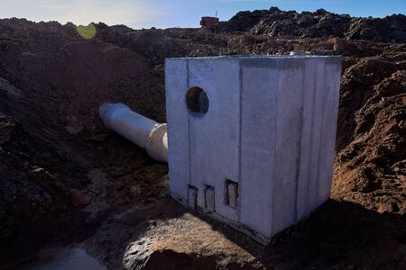 Storm sewage inlet with a pipe connected View against the sun