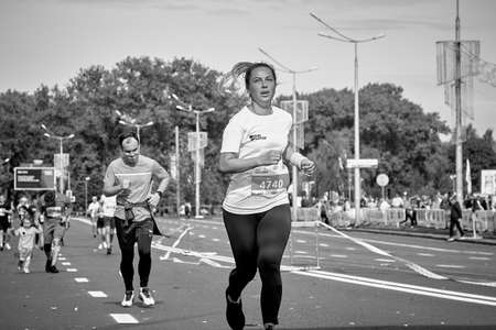 September 15, 2019 Minsk Belarus A marathon race in which a close-up of an active woman runs to the finish line of the marathonのeditorial素材