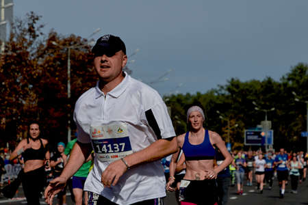 September 15, 2018 Minsk Belarus Half Marathon Minsk 2019 Close up competitor runs of the marathon Athletic young man running in the city. Healthy lifestyleのeditorial素材
