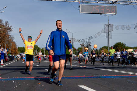 September 15, 2019 Minsk Belarus Runners crossing the finish line celebrating with arms raisedのeditorial素材