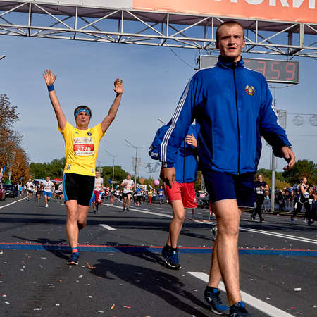 September 15, 2019 Minsk Belarus Competitors crossing the finish line celebrating with arms raisedのeditorial素材