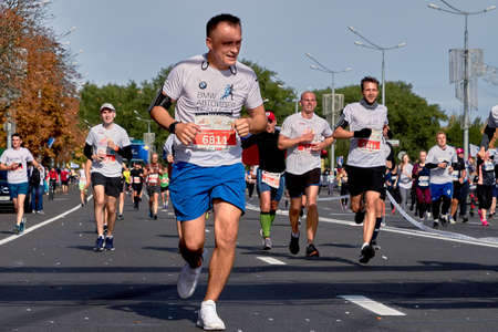 September 15, 2019 Minsk Belarus Cheerful runners running marathon on paved roadのeditorial素材