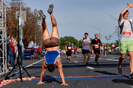 September 15, 2018 Minsk Belarus Half Marathon Minsk 2019 Muscular runner out, doing handstand...