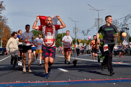 September 15, 2019 Minsk Belarus Group of unidentified people with flag crossing the finish line in the Minsk Half Marathonのeditorial素材