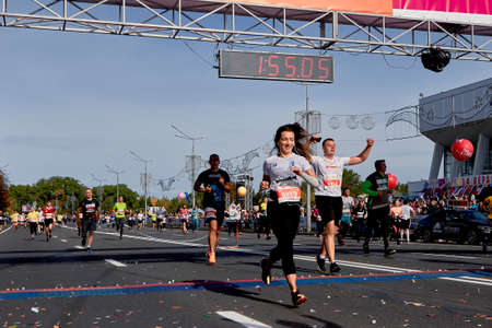 September 15, 2018 Minsk Belarus Half Marathon Minsk 2019 Runners crossing the finish line celebrating with arms raisedのeditorial素材