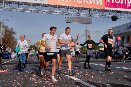 September 15, 2019 Minsk Belarus Many athletes running after the finish line marathon. Healthy lifestyle.のeditorial素材