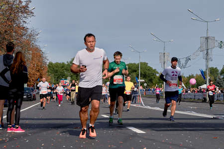 September 15, 2018 Minsk Belarus Half Marathon Minsk 2019. Crowd athletes crossing the finish line on paved road in townのeditorial素材