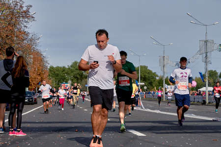 September 15, 2019 Minsk Belarus Athlete looks at the phone during a marathonのeditorial素材