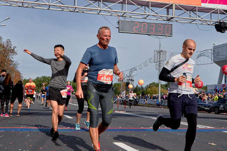 September 15, 2019 Minsk Belarus Competitor celebrates after crossing the finish line of the marathon. Group of runners cross the finish lineのeditorial素材