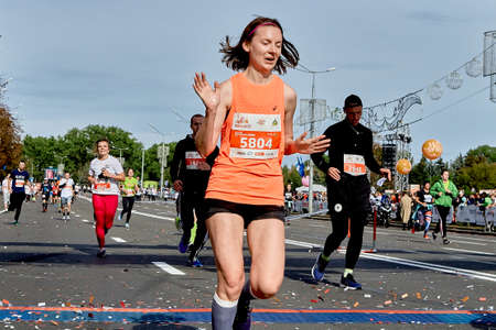 September 15, 2019 Minsk Belarus Belarus Fast woman celebrate with arms raised crossing the finish lineのeditorial素材