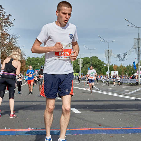 September 15, 2019 Minsk Belarus Young athlete runs after the finish line of the marathonのeditorial素材