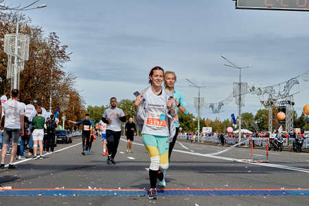 September 15, 2019 Minsk Belarus Two young women cross the finish line of a marathonのeditorial素材