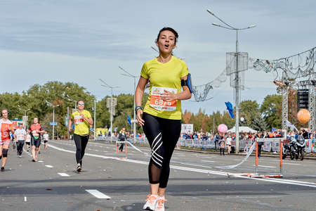 September 15, 2019 Minsk Belarus A marathon race in which an emotional woman runs to the finish line on a city roadのeditorial素材