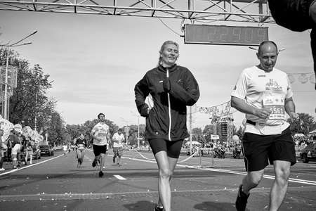 September 15, 2019 Minsk Belarus The black-and-white image shows a marathon race in which a close-up of a man and woman crosses the finish line.のeditorial素材