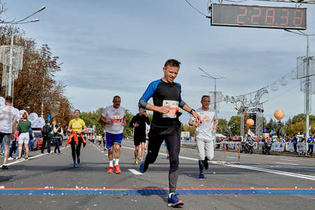 September 15, 2019 Minsk Belarus An active athlete crosses the finish line of a marathonのeditorial素材
