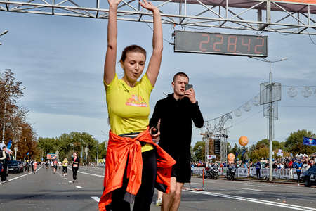 September 15, 2019 Minsk Belarus A marathon race in which a close-up of a woman crosses the finish line with her hands upのeditorial素材