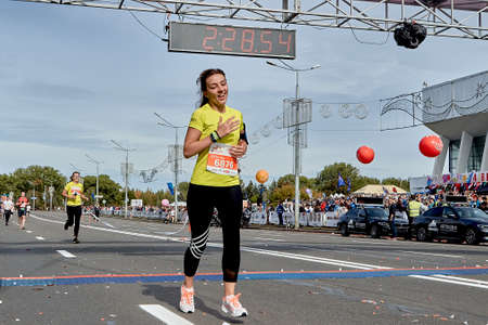 September 15, 2019 Minsk Belarus A marathon race in which a beautiful woman crosses the finish line on a city roadのeditorial素材