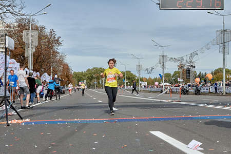 September 15, 2019 Minsk Belarus A tired woman runs to the finish line of the marathonのeditorial素材