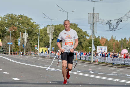 September 15, 2019 Minsk Belarus An older man runs a marathon on a city roadのeditorial素材