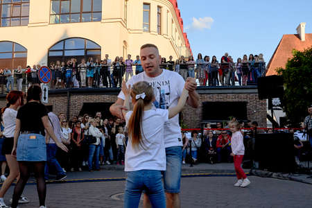 June 1, 2019 Minsk Belarus A father dances with his daughter against the blue sky in the eveningのeditorial素材
