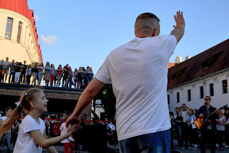 June 1, 2019 Minsk Belarus A father holds the hand of his happy daughter at a street concertのeditorial素材
