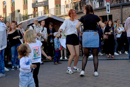June 1, 2019 Minsk Belarus A street concert in which two teenage girls dance among a crowd of peopleのeditorial素材