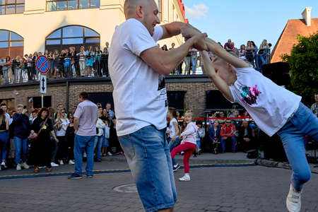 June 1, 2019 Minsk Belarus A father plays with his daughter against the blue sky in the evening on the streetのeditorial素材
