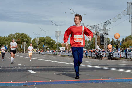 September 15, 2019 Minsk Belarus The participant crosses the finish line of the marathon on a city roadのeditorial素材